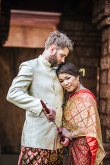 Asian bride and Caucasian groom have romantic time with Thailand dress