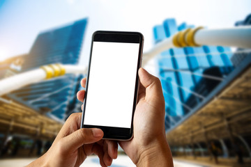 A man hand holding smart phone device in city