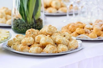 Cakes with sesame in a plate on a buffet table