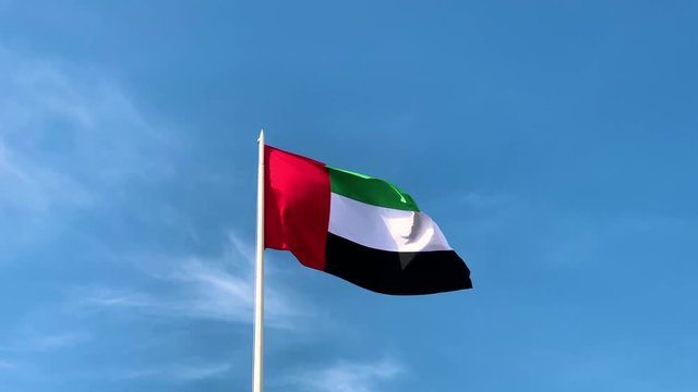 United Arab Emirates flag waving in against blue sky, uae flag perfect for film, news, digital composition, uae flag day , national day 49