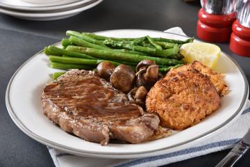 Grilled rib steak with lobster cakes