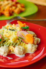 Fusilli pasta with meatballs and vegetables.