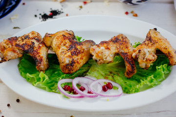 Chiken wings prepared on grill.