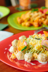 Fusilli pasta with meatballs and vegetables.
