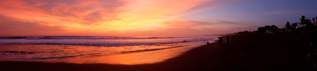 Fototapeta na wymiar A panorama of the beautiful sunset at one of the beaches of Canggu, Bali, Indonesia