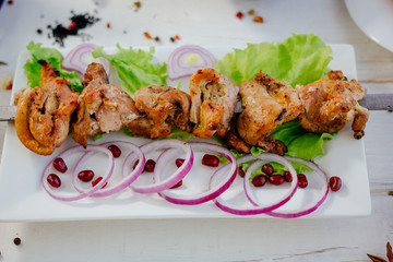 Chicken barbecue on scewer, over a white plate. Meat kebab.