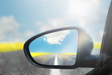 Wing mirror of a car with beautiful panorama reflected
