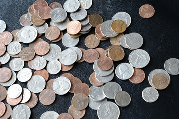 American cents scattered on a dark surface close up