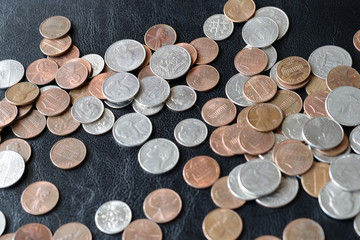 American cents scattered on a dark surface close up