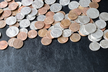American cents scattered on a dark surface close up