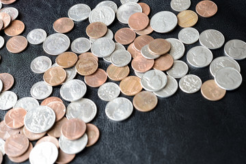 American cents scattered on a dark surface close up
