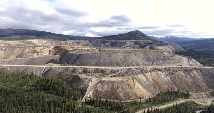 Aerial view of massive waste rock piles at abandoned mine site in Canada