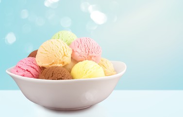 Ice cream scoops in bowl on white background