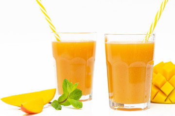Fresh tropical fruit smoothie mango juice and fresh mango on a white background. Copy space.