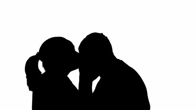 Silhouette couple man and woman kiss on a white background. Kiss between loving spouses.