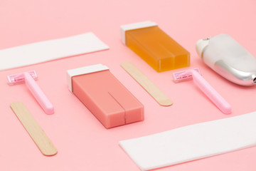 Set for epilation on pink background. The concept of hair removal. Flat lay. 