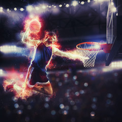 Acrobatic slam dunk of a basket player in the basket at the stadium
