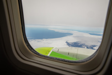 the wing of the aircraft in the window