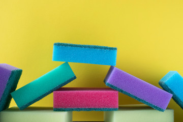 stack of cleaning kitchen sponges on trending yellow background. advertising space