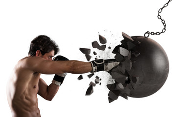 Power and determination of a young muscular boxer against a wrecking ball