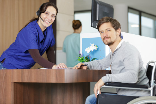 Disabled Man At The Reception Desk In A Hospital