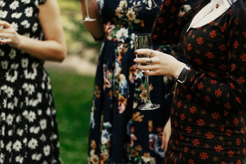 luxury elegant women holding glass of champagne and toasting at celebration in restaurant terrace