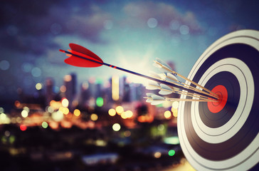 Arrow hit the center of target with modern skyline background. Business target achievement concept. 3D Rendering