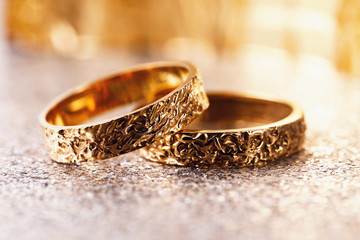 Two gold wedding rings on the table, closeup