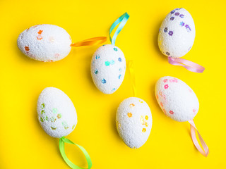 Easter holiday background. decorated easter eggs on a yellow background