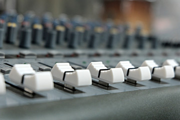 Fototapeta premium Mixing console close-up. Sound check for the concert. Mixer control. Music equipment and technology concept.