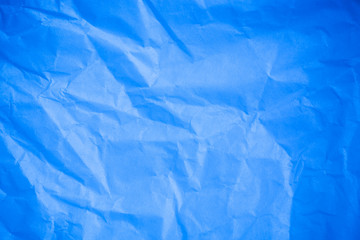 Obraz premium Crumpled blue paper background.