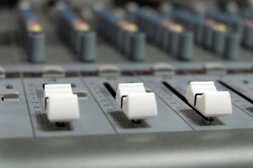 Mixing console close-up. Sound check for the concert. Mixer control. Music equipment and technology...