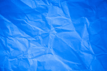 Crumpled blue paper background.