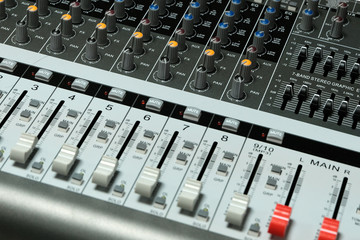 Mixing console close-up. Sound check for the concert. Mixer control. Music equipment and technology concept.