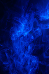 Blue smoke on black background.