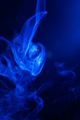 Blue smoke on black background.