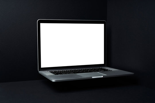 Laptop floating  with white blank screen on mockup three dimensional black background