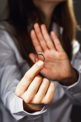 Girl holds a ring with diamond. Concept on refusal in an engagement