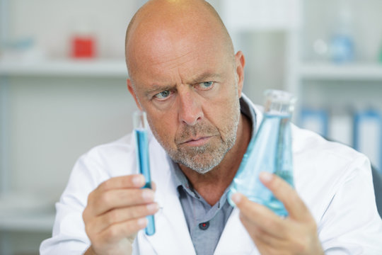 senior male researcher carrying out scientific research in a lab