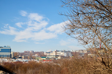 View of the city in a spring sunny day with blue sky and clouds