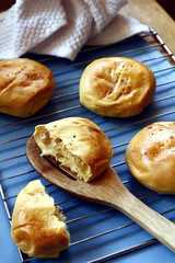 Freshly baked Filipino delicacy Pan de Coco or bread roll with sweetened coconut filling