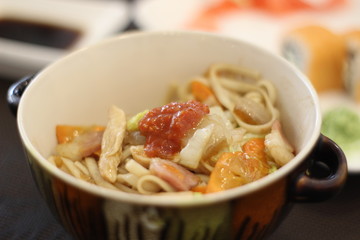 Delicious dish with noodles, chicken and vegetables in the restaurant