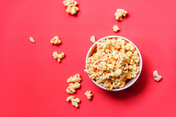 Fototapeta na wymiar Popcorn in bucket on red background / Sweet butter popcorn salt