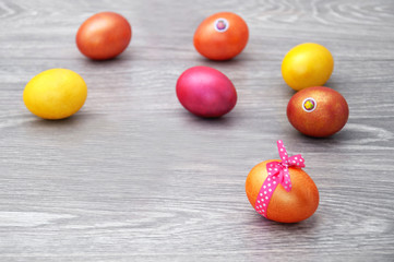 Easter eggs on a gray wooden table. Greeting card with Easter.