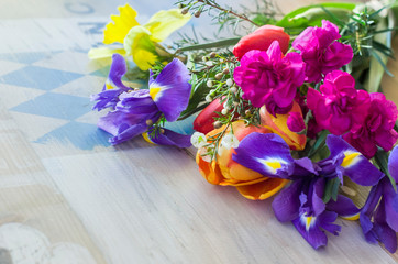 Bouquet of pink carnations, irises, tulips, narcissus.