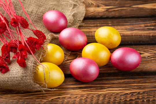 Easter eggs on a sackcloth background. Happy easter Bright multicolored shiny easter eggs. Background with easter eggs.