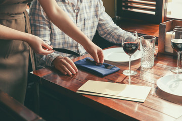 Obraz na płótnie Canvas Waiter serving guest in restaurant
