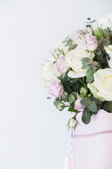 Decorative composition with fresh roses on a white background