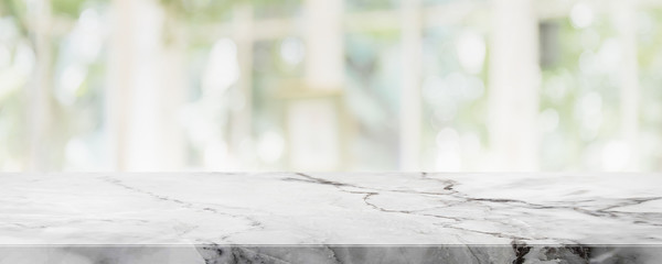 Empty white marble stone table top on blurred with bokeh shopping mall and restaurent interior...