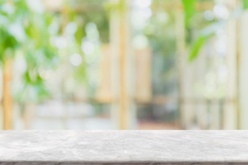 Empty white stone marble table top and blurred of interior room with window view green from tree...